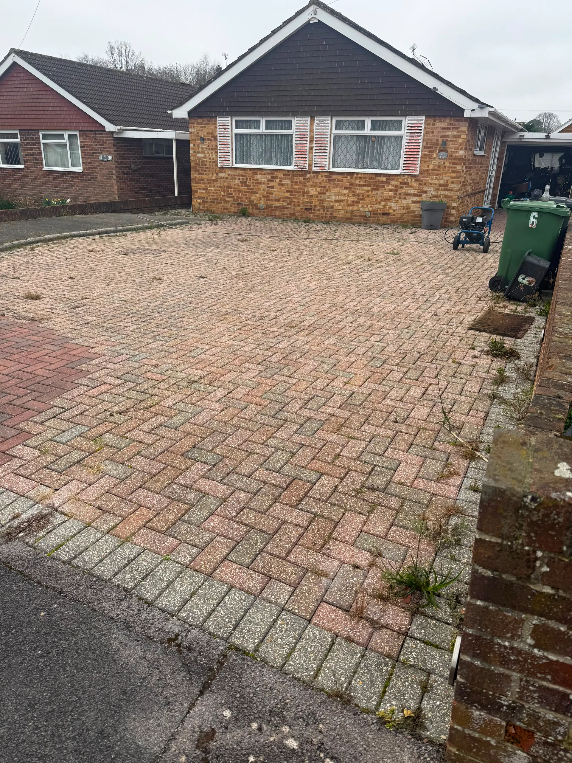 A dirty block paving driveway before professional cleaning in Hampshire