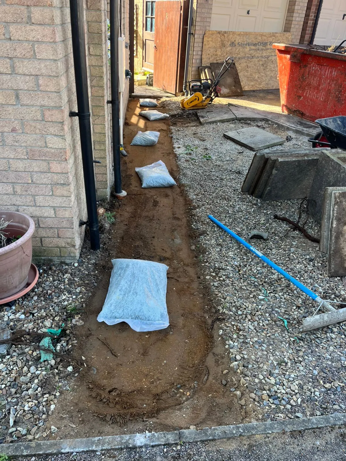 Expert groundworks in Felixstowe by FLEX PROPERTY SERVICES, preparing a sub-base for a new garden path or driveway.